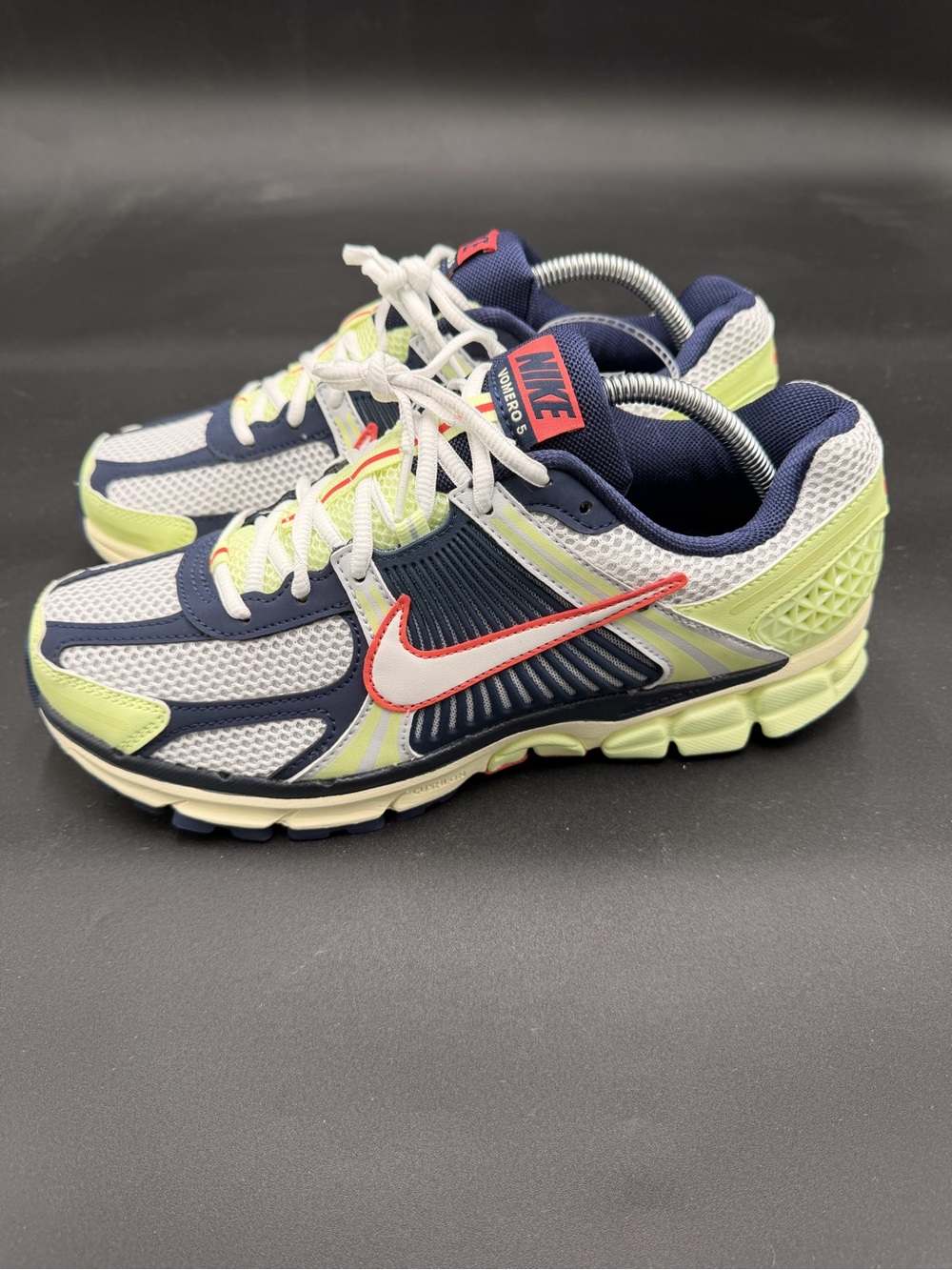 These are Nike Zoom Vomero 5 sneakers in the "Barely Volt" and "Midnight Navy"
